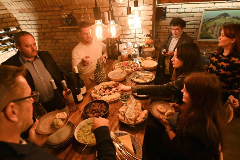Group of friends at a wine tasting in the Goldcentral cellar