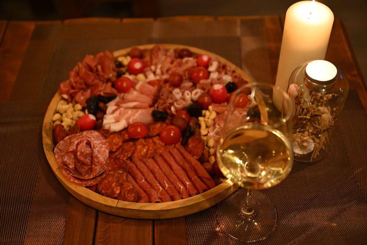 Charcuterie platter and white wine at the Goldcentral Luxury wine tasting