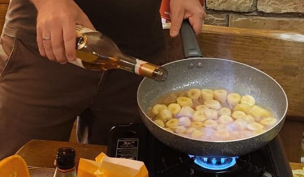 Flambéed dessert prepared at the table during a Goldcentral wine tasting