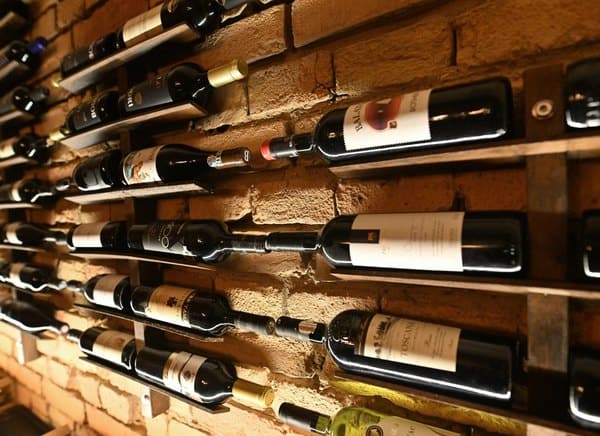 Wine wall with Hungarian wines on the brick wall of the Goldcentral cellar